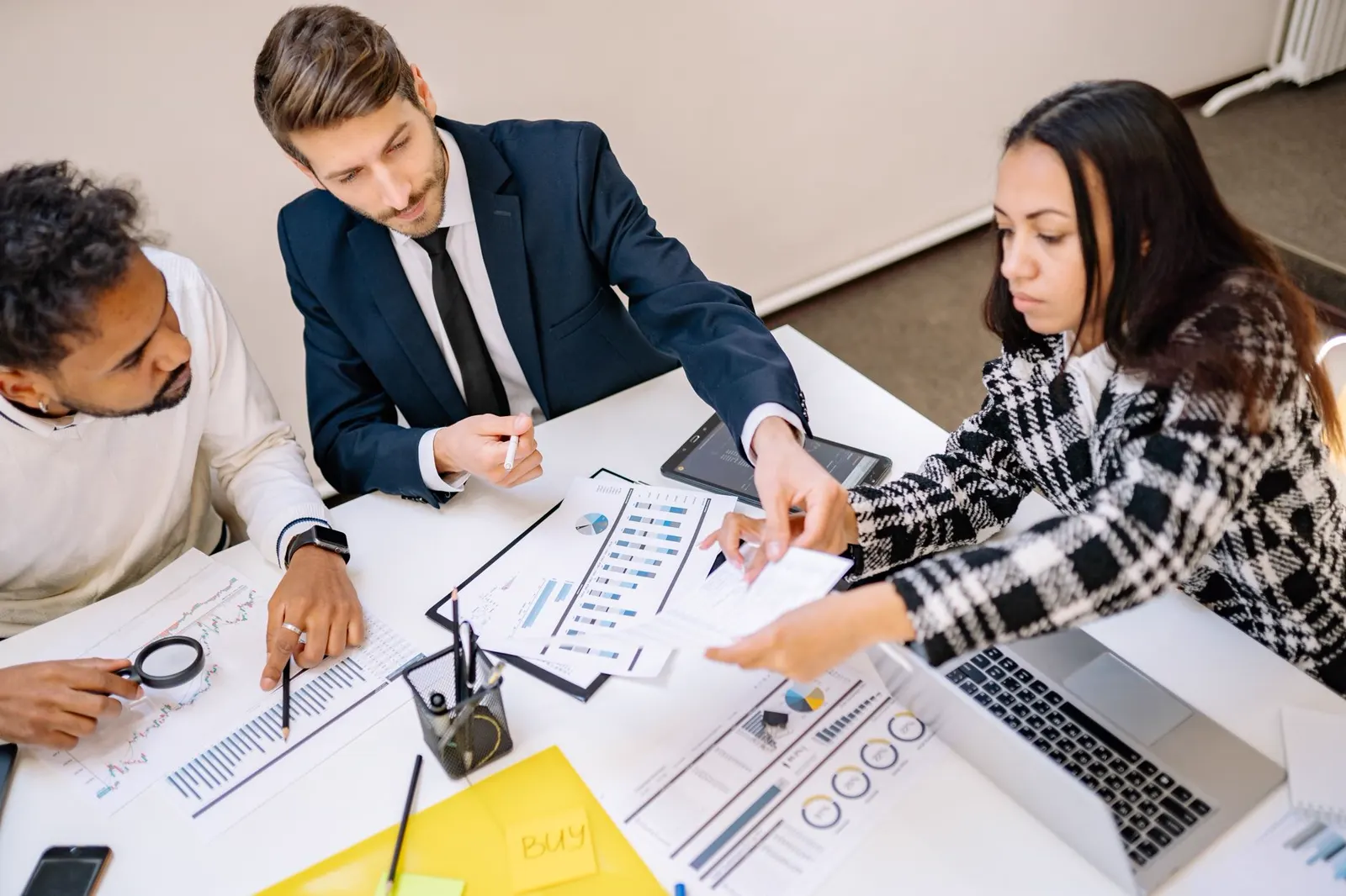A team reviews charts and reports on the table